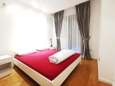 Bedroom with a double bed and a window with curtains. - image 9