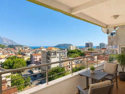 Furnished terrace with seating set and view of the city and sea. - image 11