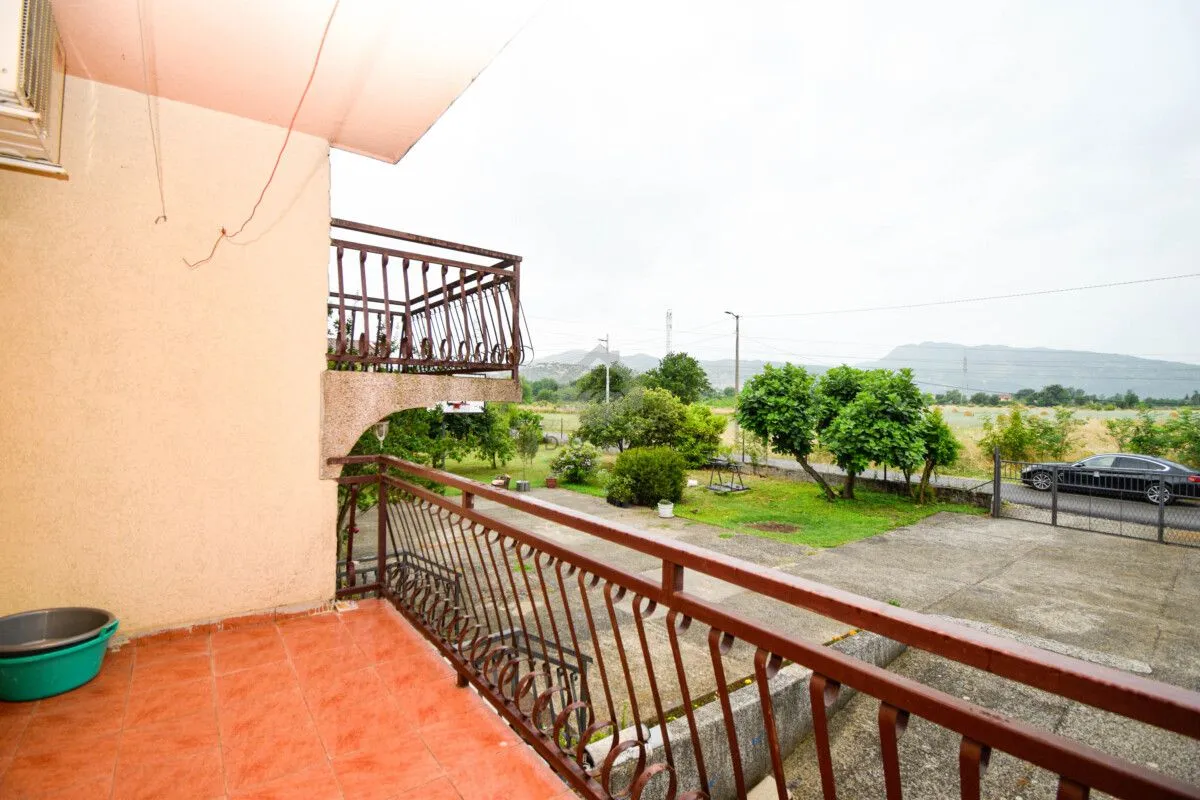 Balconies with a metal railing and a view of the courtyard and surroundings.
