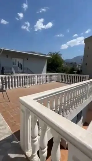 Large terrace with balustrades and surrounding view.
