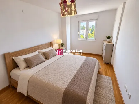 Bright and tidy bedroom with a double bed and wooden flooring. - image 6