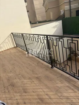 Spacious terrace with wood-effect flooring and a metal railing. - image 9