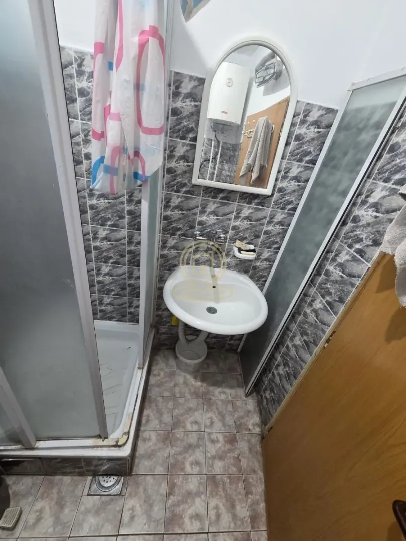 Smaller bathroom with a shower cabin and a washbasin.