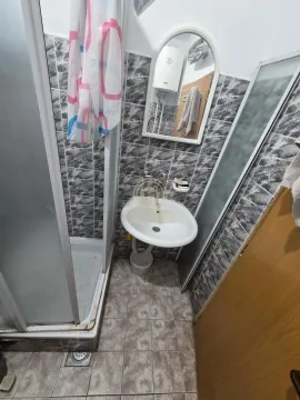Smaller bathroom with a shower cabin and a washbasin. - image 10