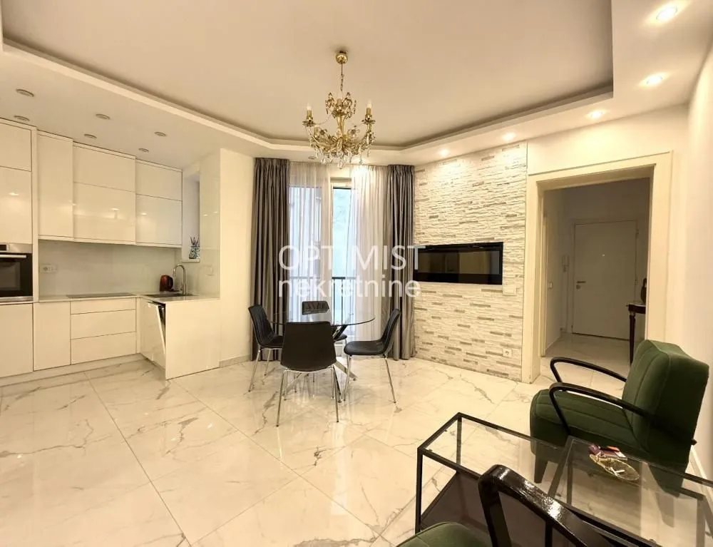 Spacious living room with a dining area and a fitted kitchen in the background.