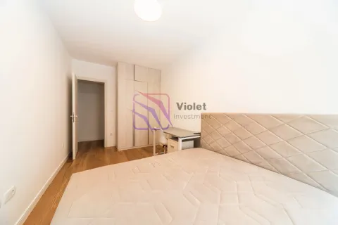 Furnished bedroom with a double bed, wardrobe, and a desk. - image 3
