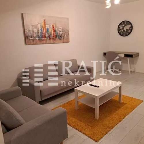 Living room with sofas, coffee table and a work area.
