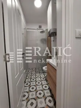 View of the bathroom with a walk-in shower through the open door. - image 7