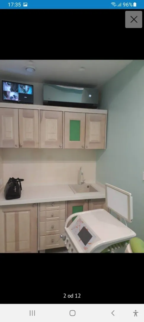 A small functional kitchen with light wooden cabinets and a sink.