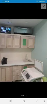 A small functional kitchen with light wooden cabinets and a sink. - image 6