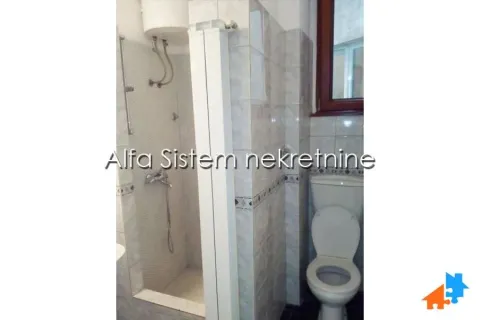 Smaller tiled bathroom with a shower cabin and a toilet. - image 9