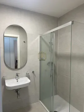 Modernly equipped bathroom with a shower cabin and washbasin. - image 5