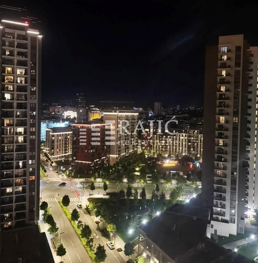 Night view from the terrace overlooking city streets and buildings.