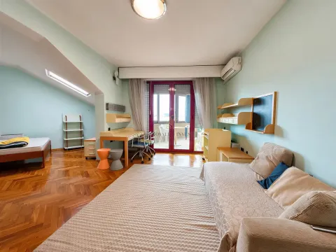 Children's room with a bed, desk, and access to the terrace. - image 14