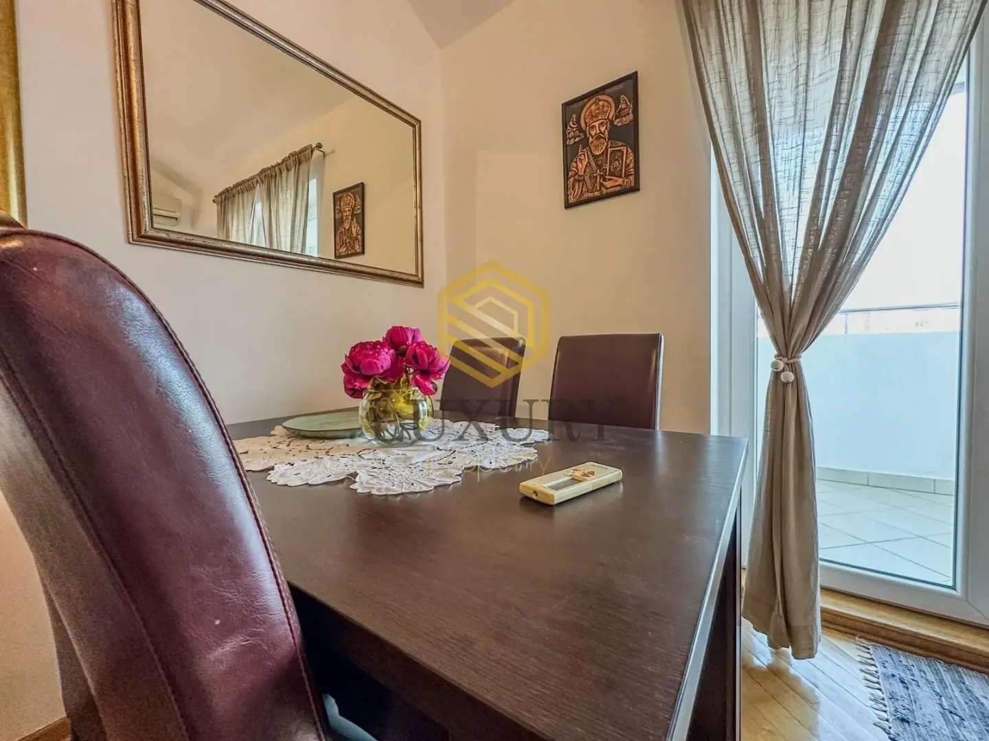 Dining area with a dark wooden table and chairs.
