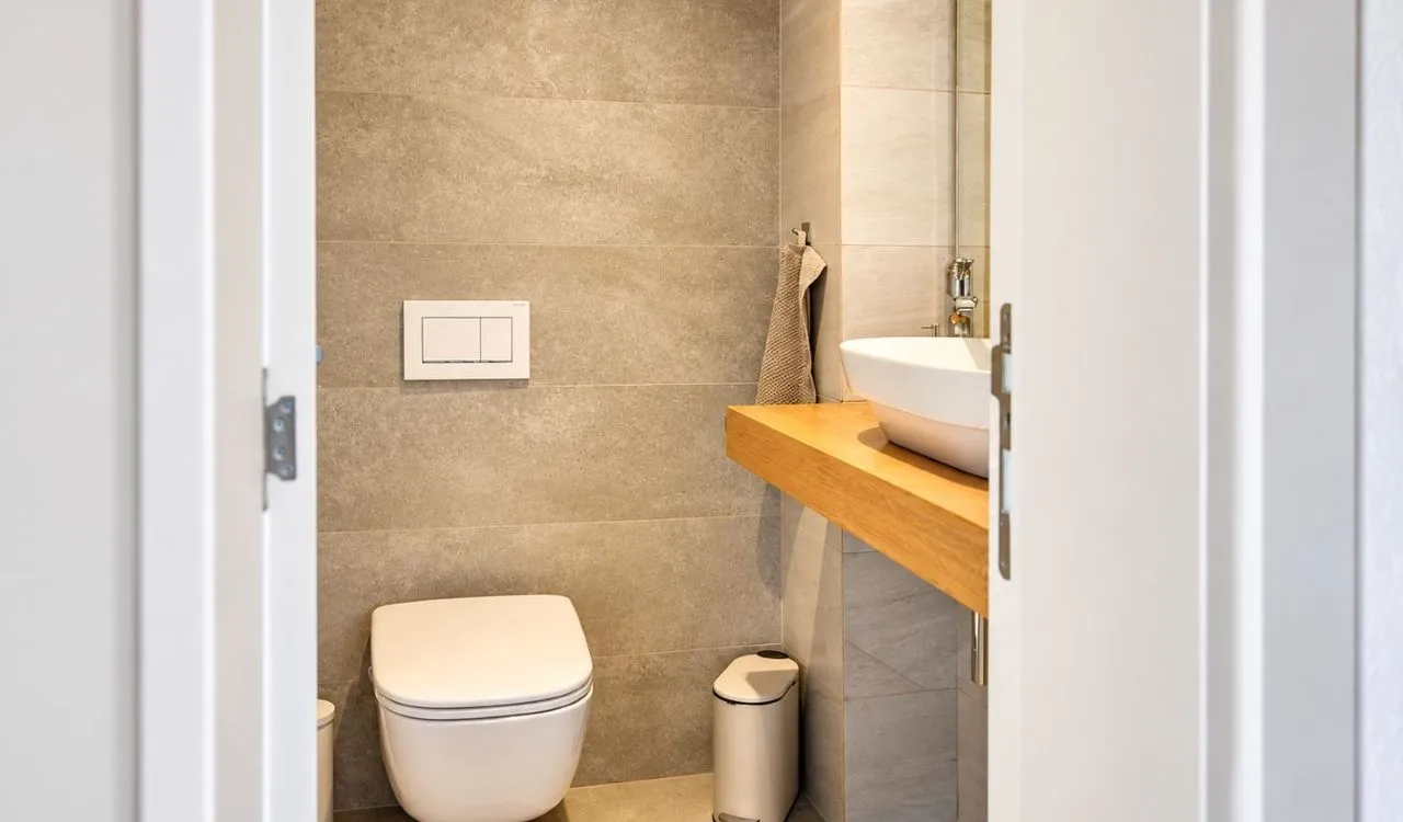 View of a modern bathroom through an open door.