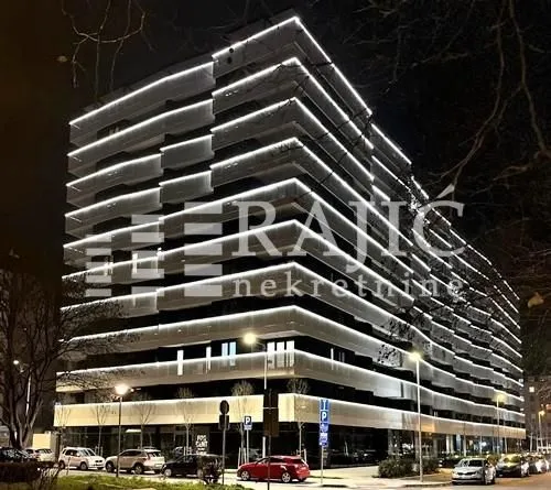 Exterior view of a modern residential building at night.