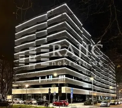 Exterior view of a modern residential building at night. - image 4