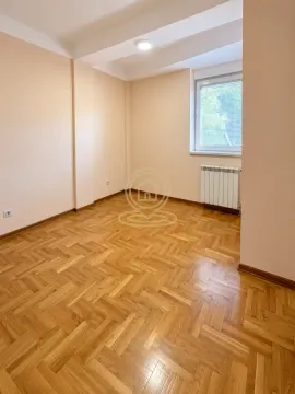 Empty room with hardwood flooring and a single window. - image 3