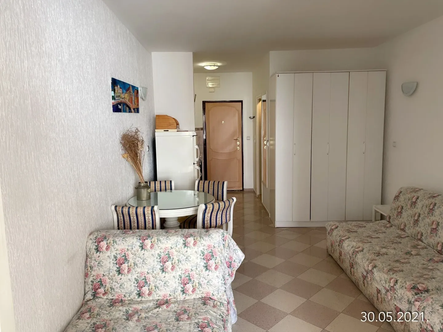 Living room with sofa set, dining table and built-in wardrobe.