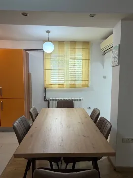 Dining area with a wooden table and chairs. - image 5