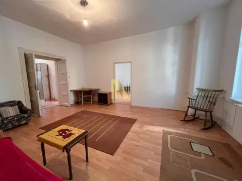 Spacious living room with wooden flooring, rugs, and furniture. - image 4