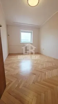 Empty room with wooden parquet flooring and a window. - image 8