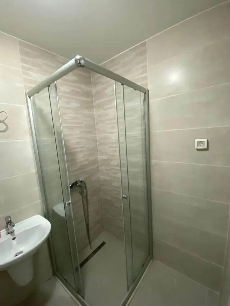 Bathroom with a shower cabin and a sink.