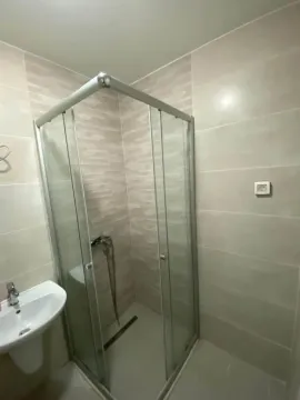Bathroom with a shower cabin and a sink. - image 8