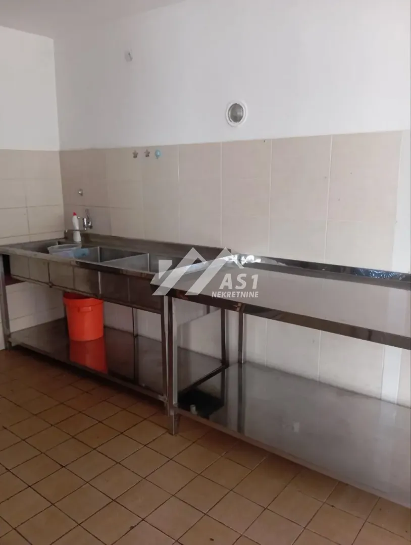 Utility kitchen with a sink and stainless steel elements.