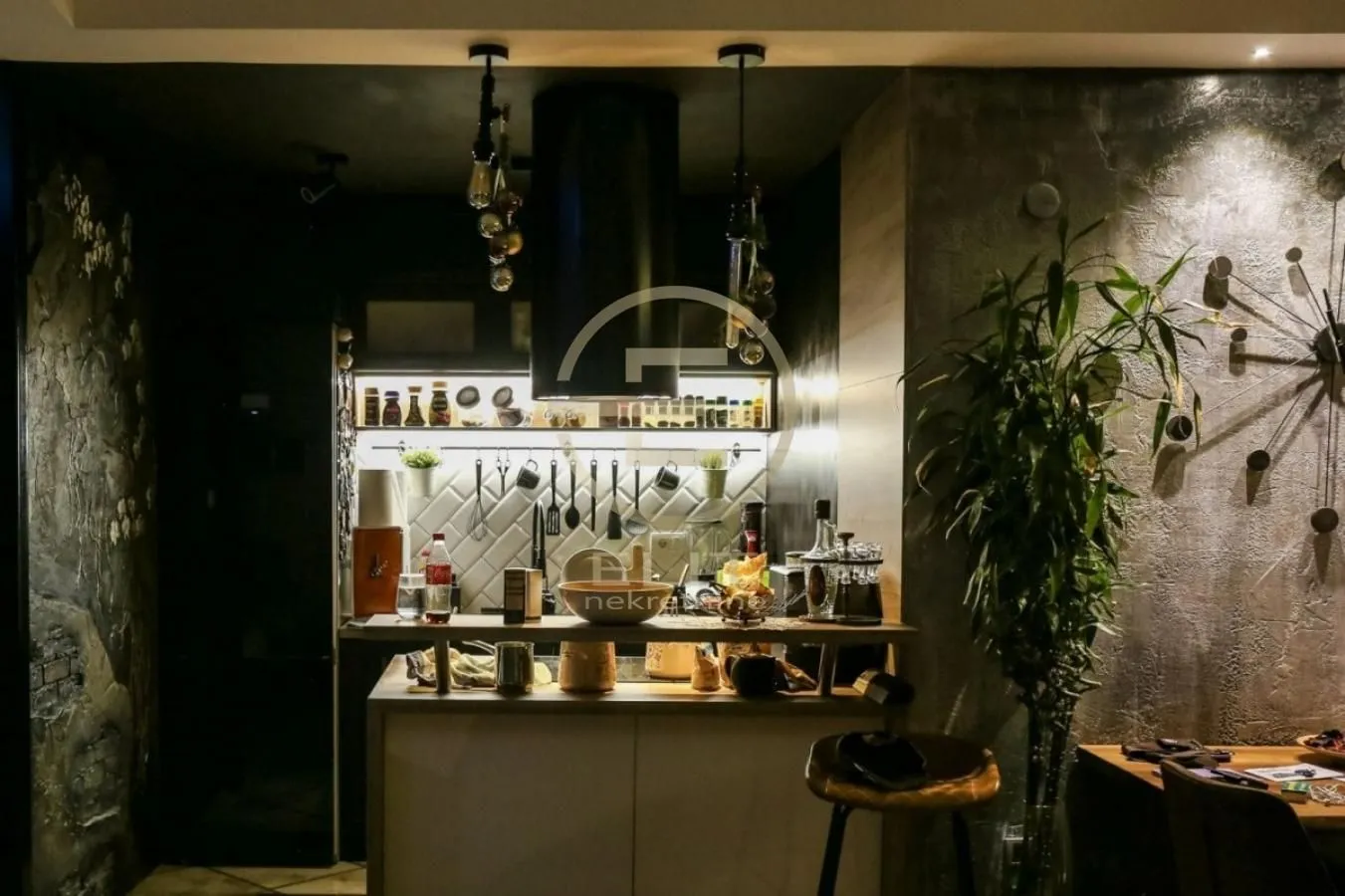 Modern kitchen with a breakfast bar and illuminated countertop.