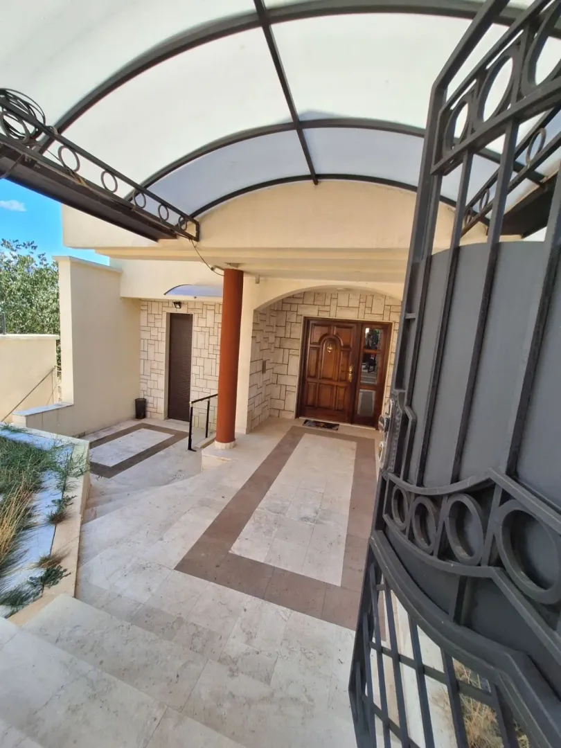 Main entrance to the house with a courtyard and canopy.