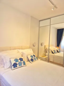 Furnished bedroom with a double bed and a large built-in mirrored wardrobe. - image 9