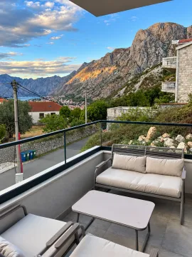Furnished balcony with seating set and a view of the mountain and bay. - image 4