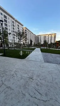 View of the courtyard and residential building facade with landscaped greenery. - image 14