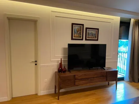 Living room with a TV unit, wall paintings, and access to the terrace. - image 2