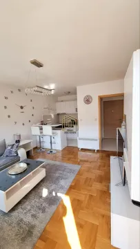 Open-plan living room with dining area and kitchen. - image 10