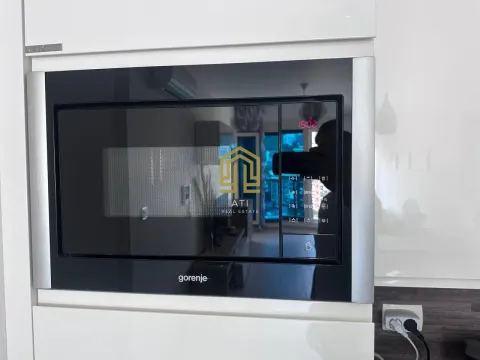 Built-in kitchen oven with white cabinetry. - image 11