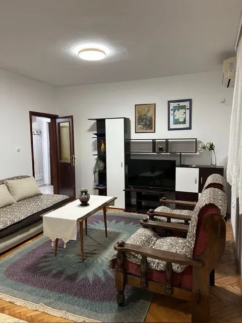 Furnished living room with a seating set and TV cabinet.