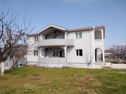 A two-story house with a yard. - image 11