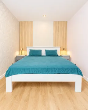 Modern bedroom with a double bed and wooden wall panels. - image 7