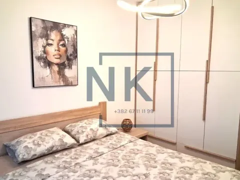 Furnished bedroom with a double bed, wardrobe, and wall art. - image 4