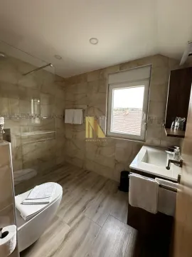 Modern equipped bathroom with a walk-in shower. - image 17