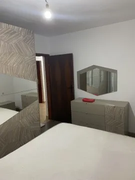 A bedroom featuring modern furniture and a mirror. - image 5