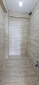 Unfurnished bathroom tiled with ceramic tiles and prepared plumbing connections. - image 15