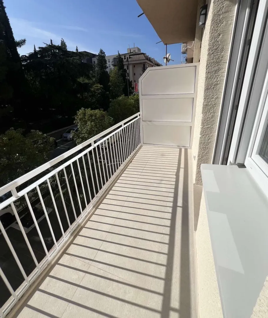 A long balcony with a white railing.