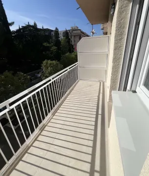 A long balcony with a white railing. - image 17