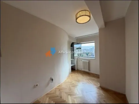 Empty room with hardwood parquet flooring and a window. - image 14