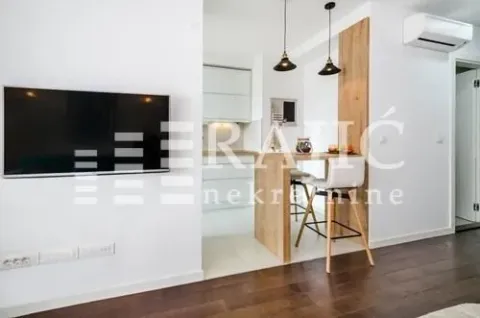 Living room with a dining area and kitchen in the background. - image 4