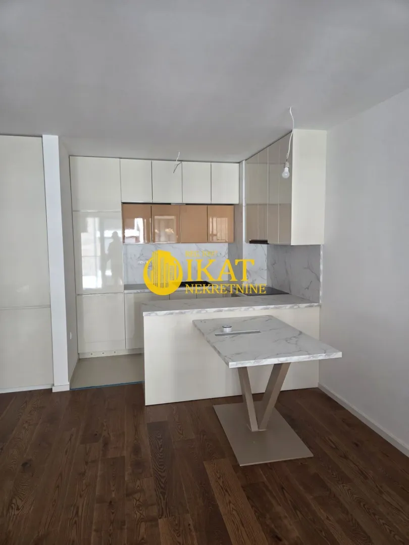 New kitchen with white cabinets and a dining table.